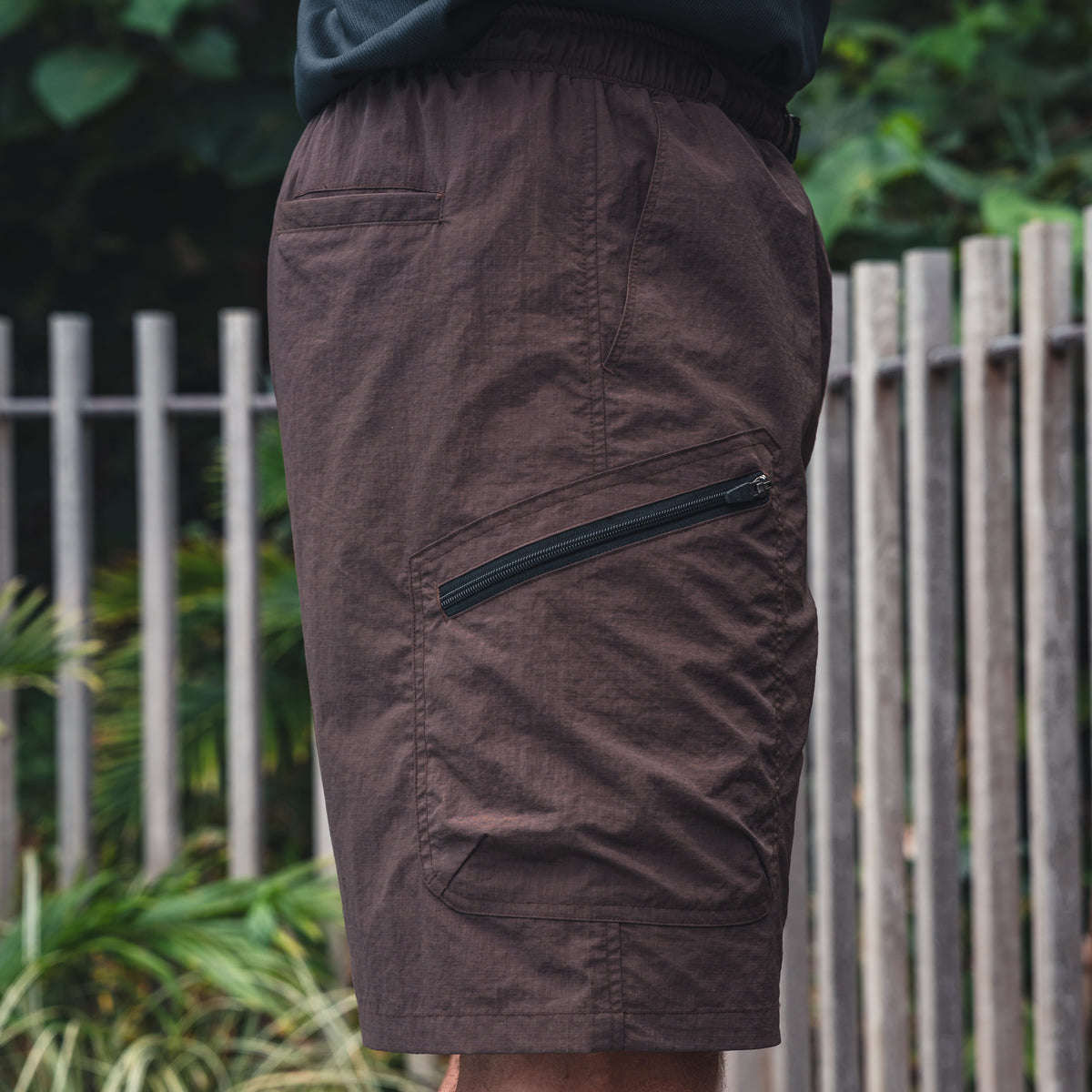Clay Groundwork Shorts at three-quarter angle with the zip pocket running along the thigh